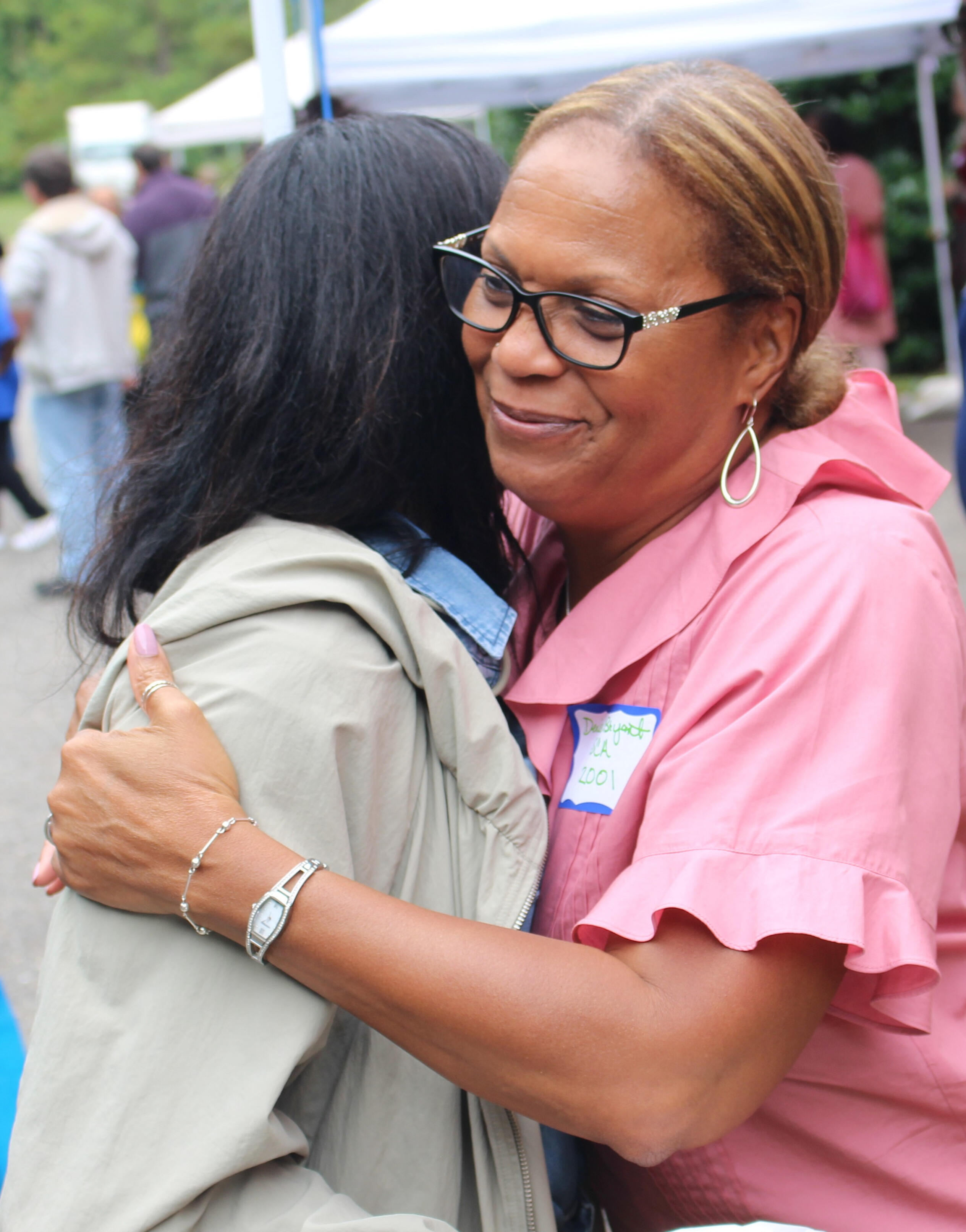 Staff hugging at employee appreciation event